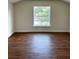 The bedroom offers hardwood floors and a window allowing natural light at 1310 Polk City Rd, Haines City, FL 33844