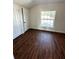 Bedroom featuring vinyl plank flooring, and a window to provide natural light at 1310 Polk City Rd, Haines City, FL 33844