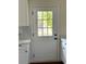 Bright kitchen door providing backyard access, complemented by white countertops and stylish backsplash details at 1310 Polk City Rd, Haines City, FL 33844