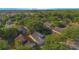 Overhead view of the home nestled amongst a community with mature landscaping and nearby power plant at 13216 Wild Duck Ct, Orlando, FL 32828