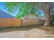 Backyard with privacy fence, mature tree, and a concrete patio area at 13216 Wild Duck Ct, Orlando, FL 32828