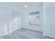 Neutral bedroom featuring wood-look floors, a bright window, and closet storage at 13216 Wild Duck Ct, Orlando, FL 32828
