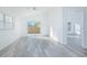 Living room showcasing plenty of natural light, an open floor plan, and sleek wood-style flooring at 13216 Wild Duck Ct, Orlando, FL 32828