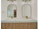 Dual sink bathroom vanity featuring designer mirrors, a modern countertop, and stylish decor at 13430 Early Frost Cir, Orlando, FL 32828