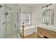 Bathroom with modern shower, soaking tub, elegant gold fixtures, and marble tile at 13430 Early Frost Cir, Orlando, FL 32828