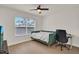 Cozy bedroom featuring a daybed, desk, ceiling fan, and a large window at 13430 Early Frost Cir, Orlando, FL 32828