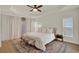 Bright bedroom with tray ceiling, plush rug, bench seating and large windows with natural light at 13430 Early Frost Cir, Orlando, FL 32828