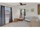 Bedroom featuring a crib, armchair, gray curtains, ceiling fan, and natural light at 13430 Early Frost Cir, Orlando, FL 32828