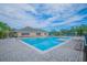 Community pool area with lounge chairs, umbrellas, and a fenced perimeter at 13430 Early Frost Cir, Orlando, FL 32828