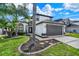 Two-story home with a two-car garage, landscaped yard, and stone walkway to front door at 13430 Early Frost Cir, Orlando, FL 32828