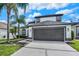 Charming two-story home with a two-car garage, manicured landscaping, and covered entry at 13430 Early Frost Cir, Orlando, FL 32828