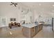 Spacious kitchen with island, adjacent dining area, and a view of the living room at 13430 Early Frost Cir, Orlando, FL 32828
