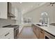 Modern kitchen with stainless steel appliances, stone backsplash, and sleek countertops at 13430 Early Frost Cir, Orlando, FL 32828