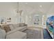 Bright living room with high ceilings, many windows, hardwood floors and a comfortable couch at 13430 Early Frost Cir, Orlando, FL 32828