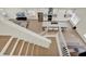 Open-concept living area with modern kitchen, an island with seating and dining and stair access at 13430 Early Frost Cir, Orlando, FL 32828
