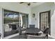 Covered outdoor dining area with pool views, stylish furniture, and a sliding glass door entry at 13430 Early Frost Cir, Orlando, FL 32828
