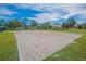 Enjoy the community volleyball court surrounded by lush landscaping and blue skies at 13430 Early Frost Cir, Orlando, FL 32828
