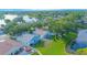 Aerial view of homes near a tranquil pond and lush green spaces in a suburban neighborhood at 13434 Mallard Cove Blvd, Orlando, FL 32837