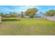 Expansive backyard with pond views, lush green grass, and mature trees at 13434 Mallard Cove Blvd, Orlando, FL 32837