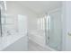 Bright bathroom featuring double sinks, tub, and glass-enclosed shower at 13434 Mallard Cove Blvd, Orlando, FL 32837