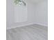 Bright bedroom featuring laminate floors, a window with blinds, and neutral walls at 13434 Mallard Cove Blvd, Orlando, FL 32837
