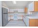 Well-lit kitchen featuring white cabinets and stainless steel refrigerator at 13434 Mallard Cove Blvd, Orlando, FL 32837