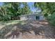 This home features a large backyard with mature trees at 136 Country Club Dr, Sanford, FL 32771