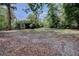 Backyard features lush greenery and mature trees, offering a private outdoor space at 136 Country Club Dr, Sanford, FL 32771