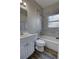 Bright bathroom featuring a shower and tub combination with marble backsplash and modern gray flooring at 136 Country Club Dr, Sanford, FL 32771