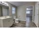 This bathroom features a modern vanity, toilet, and wood-look floors at 136 Country Club Dr, Sanford, FL 32771