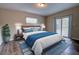 Comfortable bedroom with a large bed, wood flooring, and sliding glass door at 136 Country Club Dr, Sanford, FL 32771
