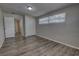 This bedroom features wood flooring, a window with blinds, and a double-door closet at 136 Country Club Dr, Sanford, FL 32771