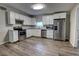 Modern kitchen featuring stainless steel appliances, ample cabinet space, and luxury vinyl plank flooring at 136 Country Club Dr, Sanford, FL 32771