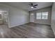 Spacious living room featuring vaulted ceilings, new luxury vinyl plank floors, and a ceiling fan at 136 Country Club Dr, Sanford, FL 32771