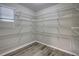Spacious pantry featuring white wire shelving and modern gray wood-look flooring at 136 Country Club Dr, Sanford, FL 32771