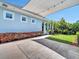 Charming backyard with concrete pavers, lush plants, and a sunshade at 13662 Behring Ave, Orlando, FL 32827