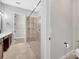 Bathroom featuring a tiled shower with glass doors and a separate walk-in closet at 13662 Behring Ave, Orlando, FL 32827