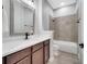 Bathroom featuring white countertops, dark vanity, tile shower-tub combination, and modern finishes at 13662 Behring Ave, Orlando, FL 32827
