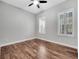 Empty bedroom with wood flooring, ceiling fan, and a window with plantation shutters at 13662 Behring Ave, Orlando, FL 32827