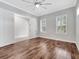 Bedroom with hardwood floors, ceiling fan, shuttered windows, and a large doorway to an office space at 13662 Behring Ave, Orlando, FL 32827