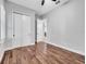 Bright bedroom featuring wood floors, double closets, and views into the hallway and a walk-in closet at 13662 Behring Ave, Orlando, FL 32827