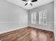 Bright bedroom featuring wood floors, a ceiling fan, and shuttered windows at 13662 Behring Ave, Orlando, FL 32827