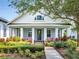 Beautiful home with an inviting porch, well-manicured landscaping, and charming architectural details at 13662 Behring Ave, Orlando, FL 32827