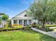 Charming home featuring a landscaped front yard, welcoming porch, and beautiful architectural details at 13662 Behring Ave, Orlando, FL 32827