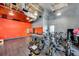 Bright fitness center features modern cycling equipment, a mirrored wall, and an orange accent wall at 13662 Behring Ave, Orlando, FL 32827