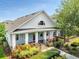 Charming home featuring a covered front porch and beautiful landscaping at 13662 Behring Ave, Orlando, FL 32827