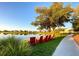 A picturesque lake view with adirondack chairs and a tranquil setting for relaxation and enjoying nature at 13662 Behring Ave, Orlando, FL 32827
