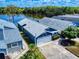 Picture of a charming blue home next to a serene lake, lush greenery, and neighborhood homes at 148 Meadow Blvd, Sanford, FL 32771