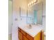 Cozy bathroom with single sink vanity with wood cabinets and white countertops at 148 Meadow Blvd, Sanford, FL 32771