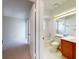 Bathroom next to a bedroom with single sink vanity with wood cabinets at 148 Meadow Blvd, Sanford, FL 32771